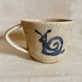 Oatmeal speckled mug with a hand-painted navy snail