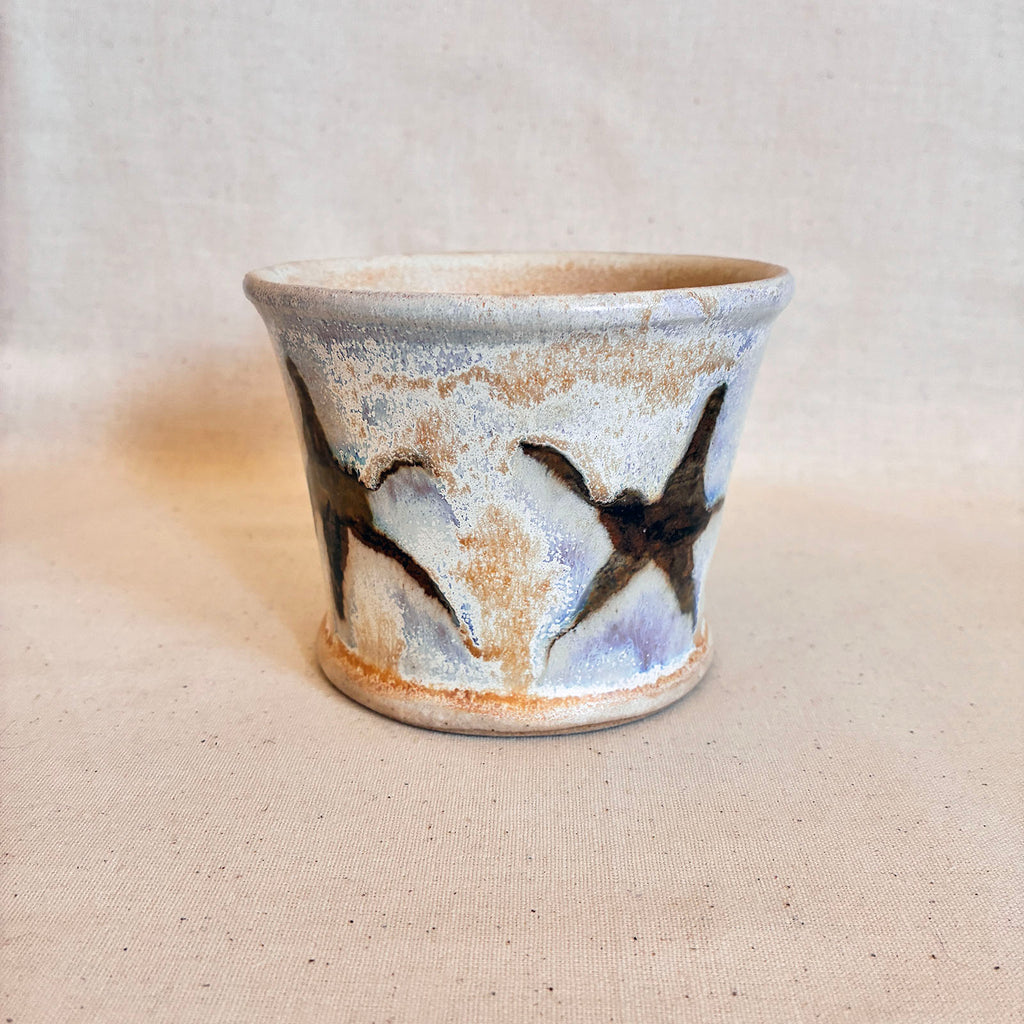 Cream and tenmoku brown fluxed glaze taper pot with star graphic