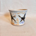 Cream and tenmoku brown fluxed glaze taper pot with star graphic