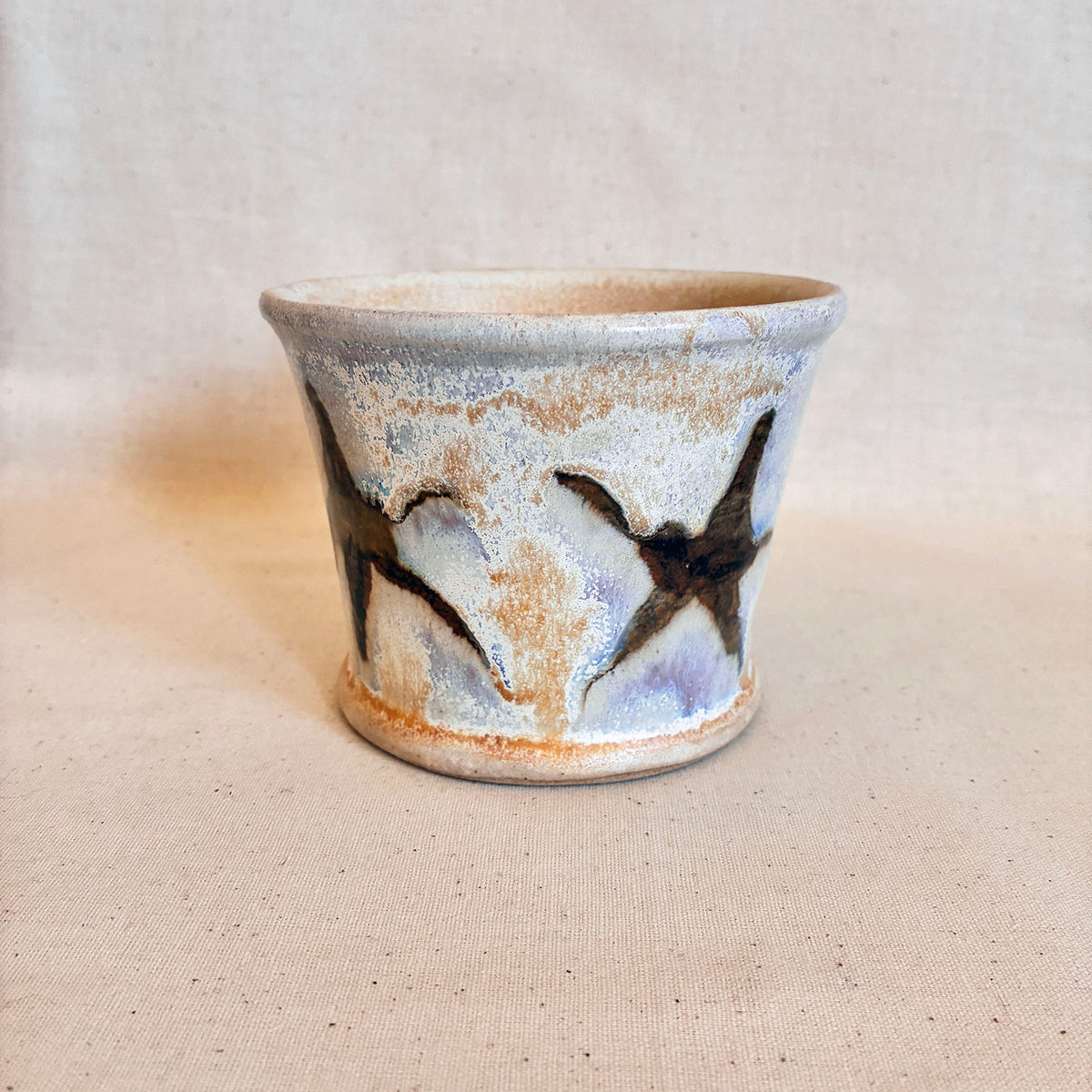 Cream and tenmoku brown fluxed glaze taper pot with star graphic