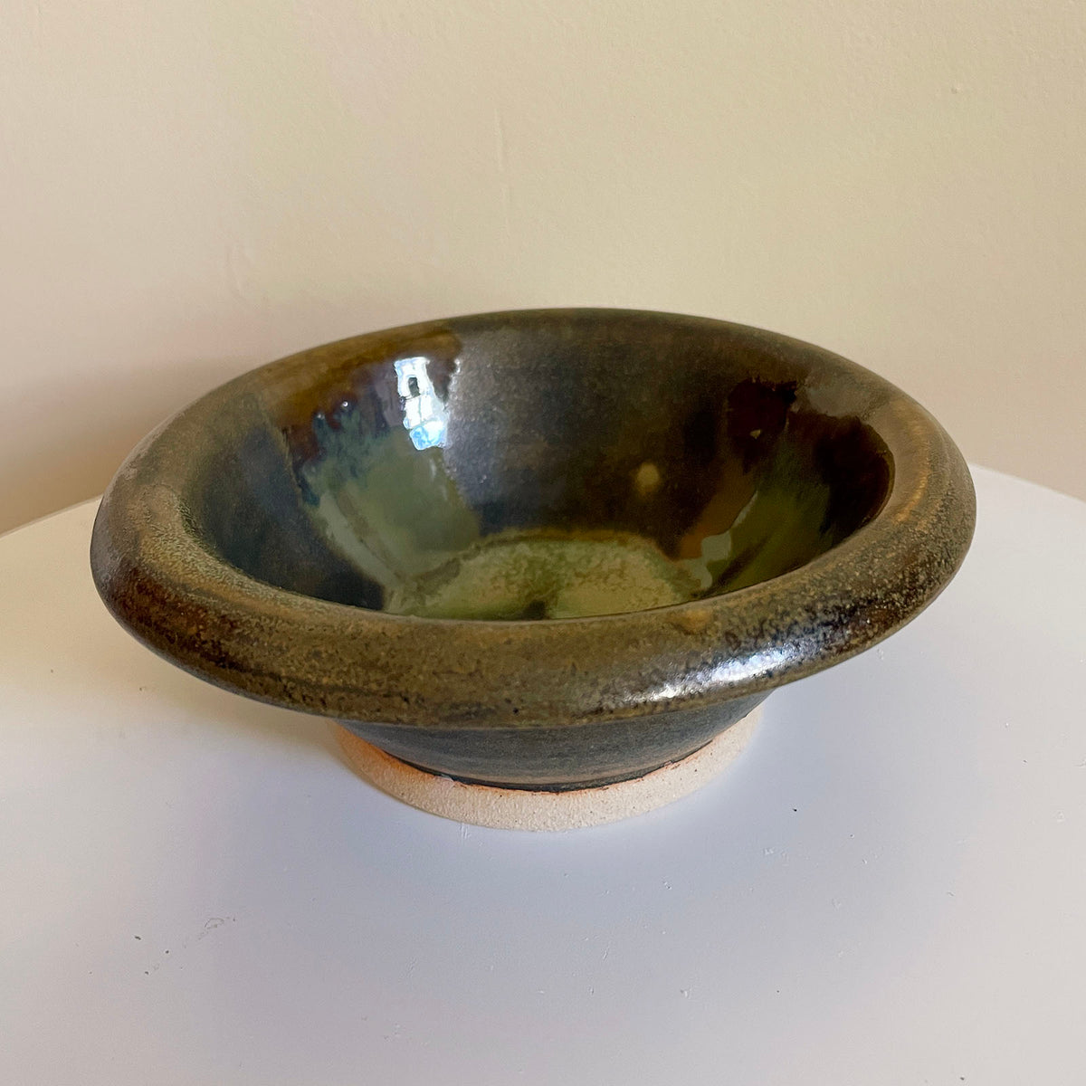 Bubble-rim bowl with drippy glossy brown and mossy-green glazes